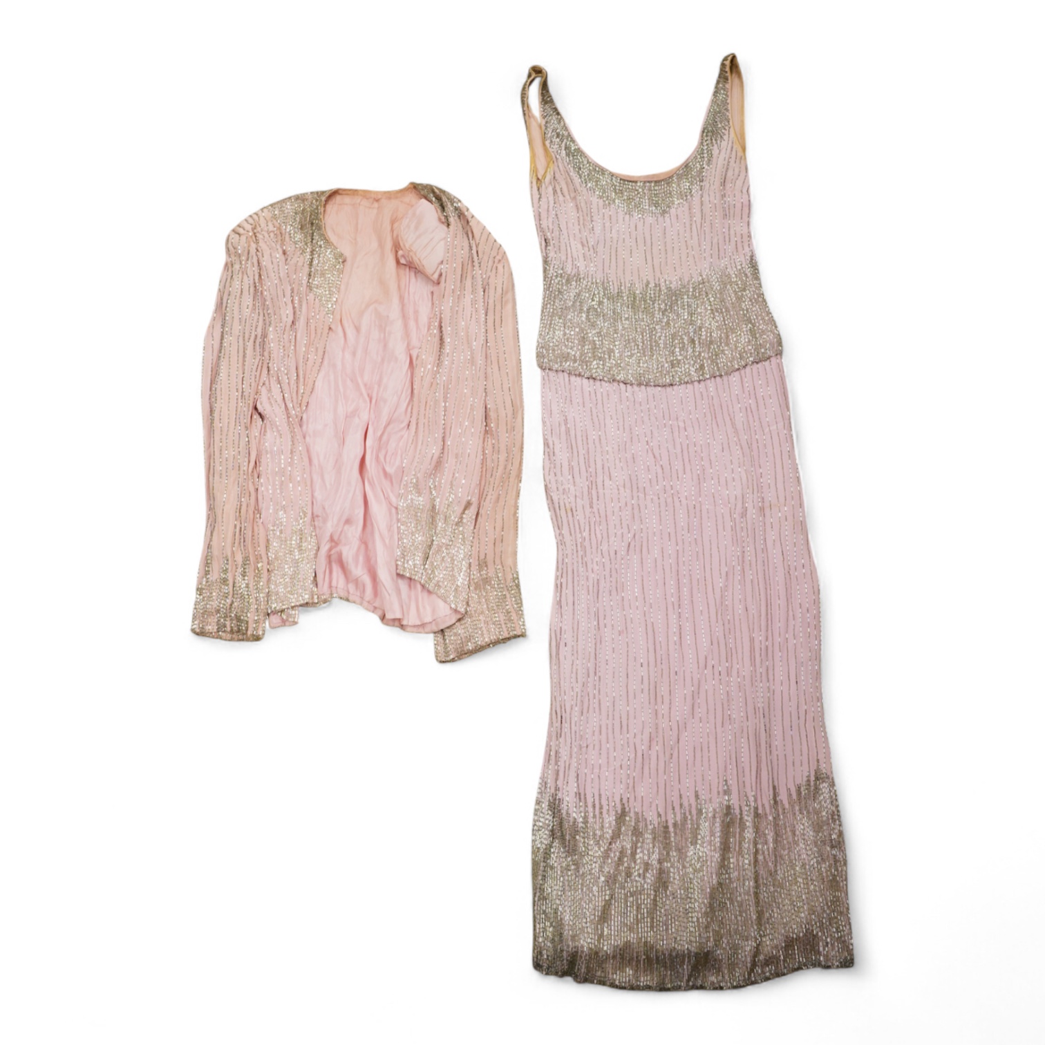 A mid to late 20th century pink and silver beaded evening dress-120cm long, with matching jacket, together with a green net beaded full length evening dress with mushroom lining and back split.